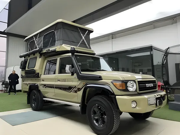 Khaki Toyota Land Cruiser 79 with a tray-mount camper and pop-up roof