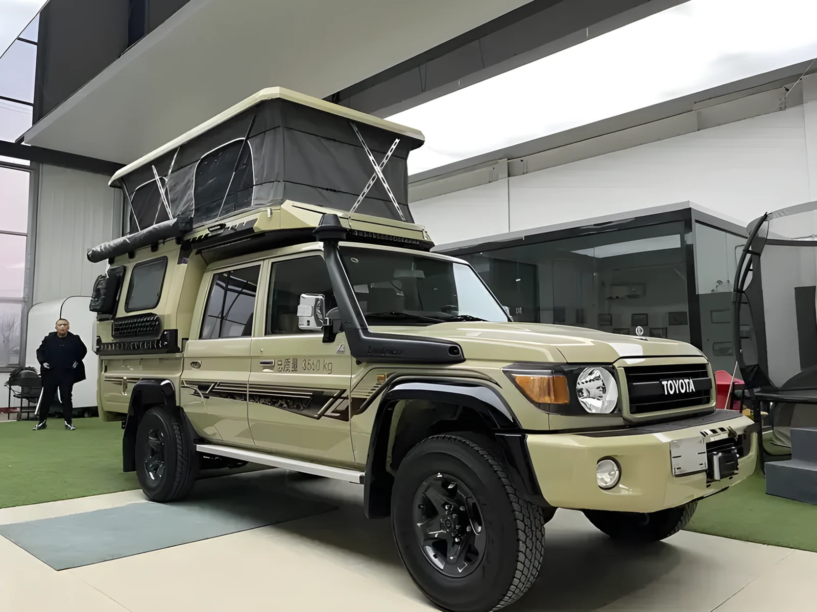 Toyota LandCruiser 79 with a SUNHOMEE tray-mount camper, roof raised