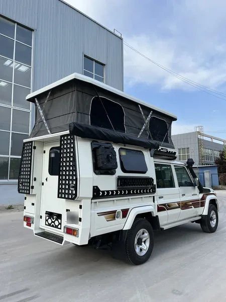 Rear view of a white SUNHOMEE slide-on camper on a LandCruiser 79